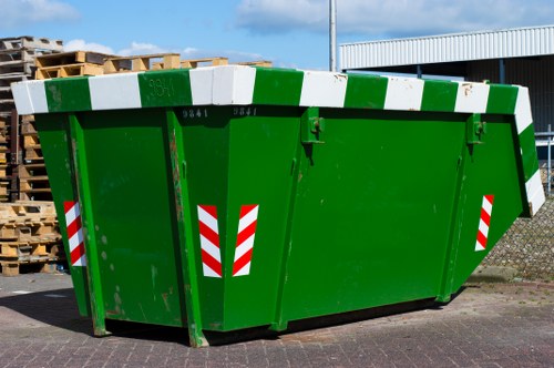Recycling bins and signage in a Greenwich commercial waste area